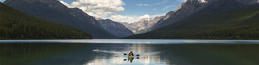 Kayaker in scenic mountain lake.